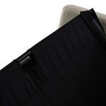 Side view of sleeper mechanism folding out from beneath seat with black fabric covering