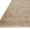 Side angle view showing rug’s fringed edge and flat woven texture