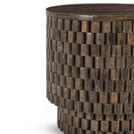 Side angle view highlighting the layered block texture wrapping the Norwood round table
