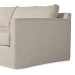 Close-up side view of slipcovered sectional arm with tight fabric wrap