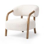 Angle from front-left showing oak frame legs and rounded ivory upholstery in detail