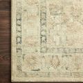 Extreme close-up of Rosette rug’s detailed faded pattern and soft pile on dark hardwood floor
