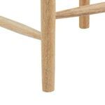 Highly detailed close-up of natural wood grain and rounded edge of Oslo stool leg