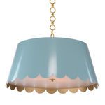Scalloped pendant light shade in light blue with gold interior hanging from gold chain