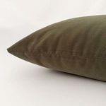 Side view showing the soft velvet texture and subtle seam detail of the olive green pillow cover