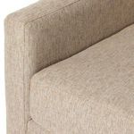 Lower side angle showing tapered wooden feet and cushioned front base