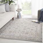 Odel rug styled in living room with light sofa, silver side table, and large window background