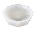 Angle view from above showing translucent alabaster material and carved geometric shape