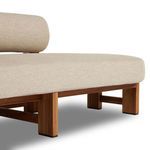 Bottom corner detail showing teak legs with protective black caps and cushion base