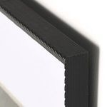 close-up of black frame corner showing textured carved details and wood grain finish