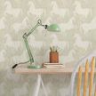 Wallpaper behind a light wood desk with green adjustable lamp, pencil holder, and wooden chair in room setting