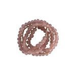 Multiple strands of blush pink sea glass beads stacked, highlighting frosted surfaces