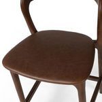 Extreme close-up showing detailed texture of brown top-grain leather seat