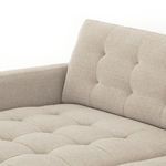Detailed view of tufted back cushion and low armrest with pewter fabric texture