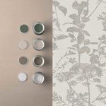 Esther Wallpaper alongside matching paint pots in muted green, taupe, and grey shades on beige surface
