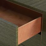 Open drawer showing smooth wooden interior contrasting with olive grasscloth exterior