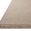 Close-up angled view showing the texture and fringe detail on one edge of the rug