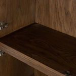 Interior close-up showing dark wood shelf surface and subtle wood grain