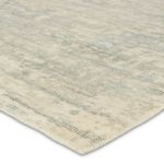 Close-up view of rug edge showing texture and woven teal cream fibers