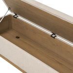 Interior close-up showing oak wood storage compartment inside trunk with drain hole