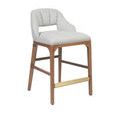 Angled side view with lighting that emphasizes wood grain and brass detail on footrest