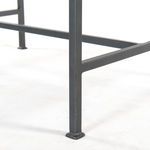 Detail of gunmetal iron leg with square foot on end table frame