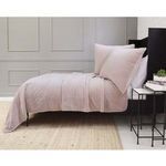 Side view of the Amsterdam Coverlet draped over a bed showing its lightweight and relaxed drape