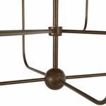 Close-up of central spherical hub connecting the chandelier arms in brushed copper