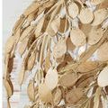 Close-up showing texture and patina of oval bleached coconut shell petals and curved metal branches