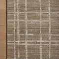 Wade Brown Stone Rug corner on wood floor highlighting fringed edge and linear pattern