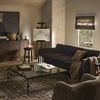 Living room setting with Julius Swivel Chair paired with dark sofa and glass coffee table