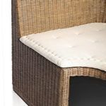 Three-quarter front view showing rattan texture variations and beige cushion