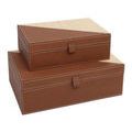 Overhead view of four trays with leather and raffia plus small rustic decorative items
