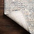 Lucia rug corner lifted up showing non-slip backing and tightly woven construction