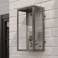 Outdoor wall sconce mounted on white brick in natural light, visible front and side angles