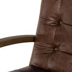 Close-up of upper backrest corner showing rounded edge with deep brown button tuft.
