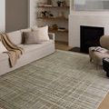 Wade Mist Gold Rug styled in minimalist living room with beige sofa and fireplace