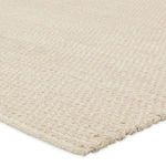 Close-up of warm beige braided weave showing detailed handcrafted texture
