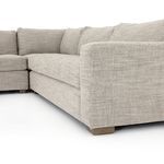 Side angle showing extended left corner with squared armrest and cushion depth