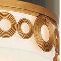 Close-up of brass-finished wrought iron circular decorative elements and top metal frame