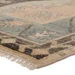 Close-up side view showing thick handknotted wool texture and fringe detail on Bhima rug