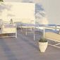 Sabbia Loveseat set in outdoor patio arrangement with matching armchairs and coffee table on wood deck