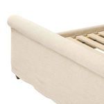 Close-up view of footboard fabric corner with precise seam and rolled upholstery edge