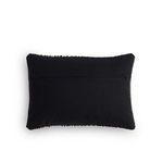 Back side of pillow showing solid black fabric with concealed zipper closure