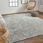 Living room setup with the rug on wood floor alongside cream sofa and woven basket with throw