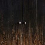 close-up view of cabinet doors and round knobs casting soft shadows on wood panel