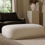 Marion Ottoman styled in living room beside dark brown leather sectional sofa and neutral decor