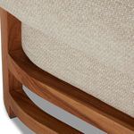 Detail showing curve of teak base frame with fabric upholstery on chaise edge