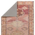 Backside flipped corner showing rug's woven backing and reverse color palette