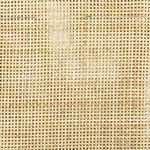 Close-up of natural cane weave texture on the chair back